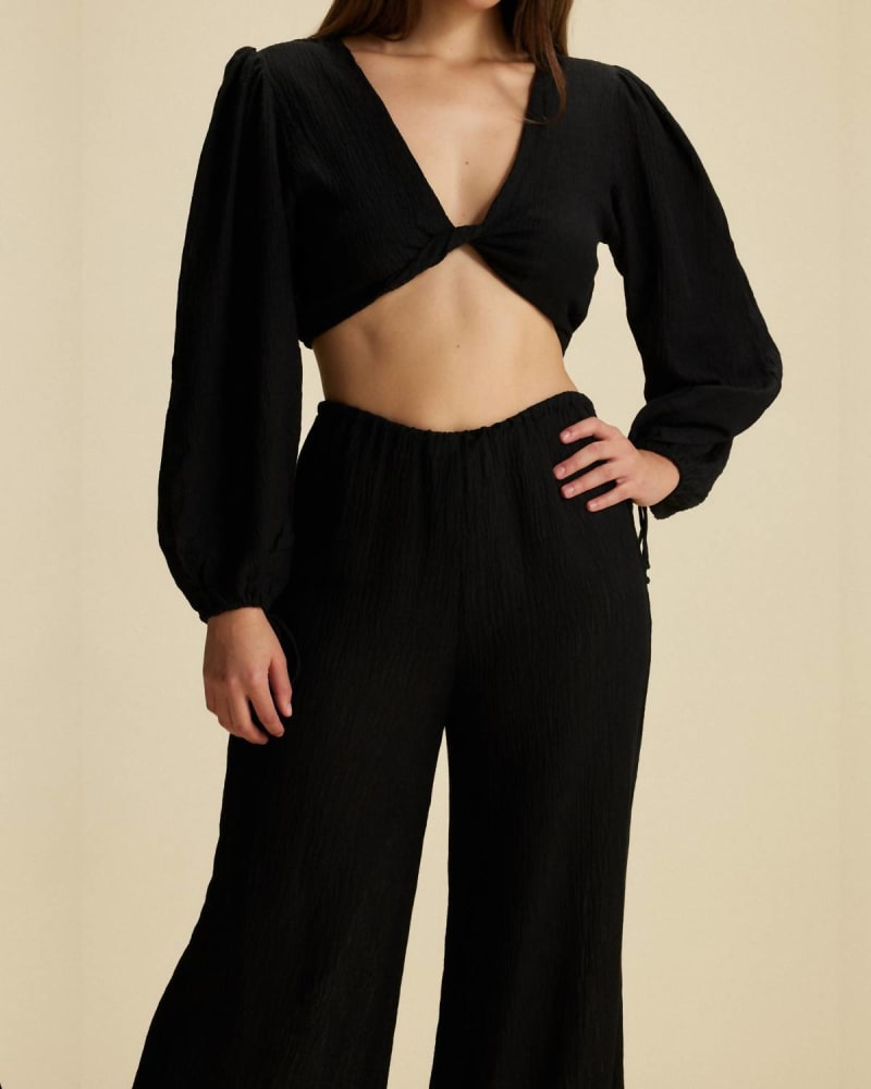 Front of a model wearing a size L Palmera Top in Black in Black by FAITHFULL THE BRAND. | dia_product_style_image_id:343556